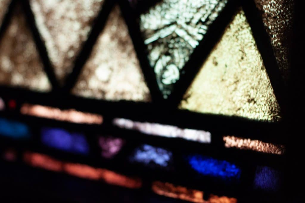 Light shining through a stain glass window with traingles at UU Wausau.