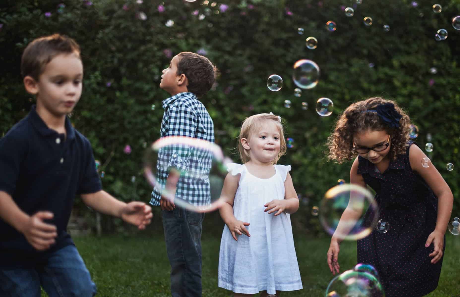 Young kids blowing bubbles.