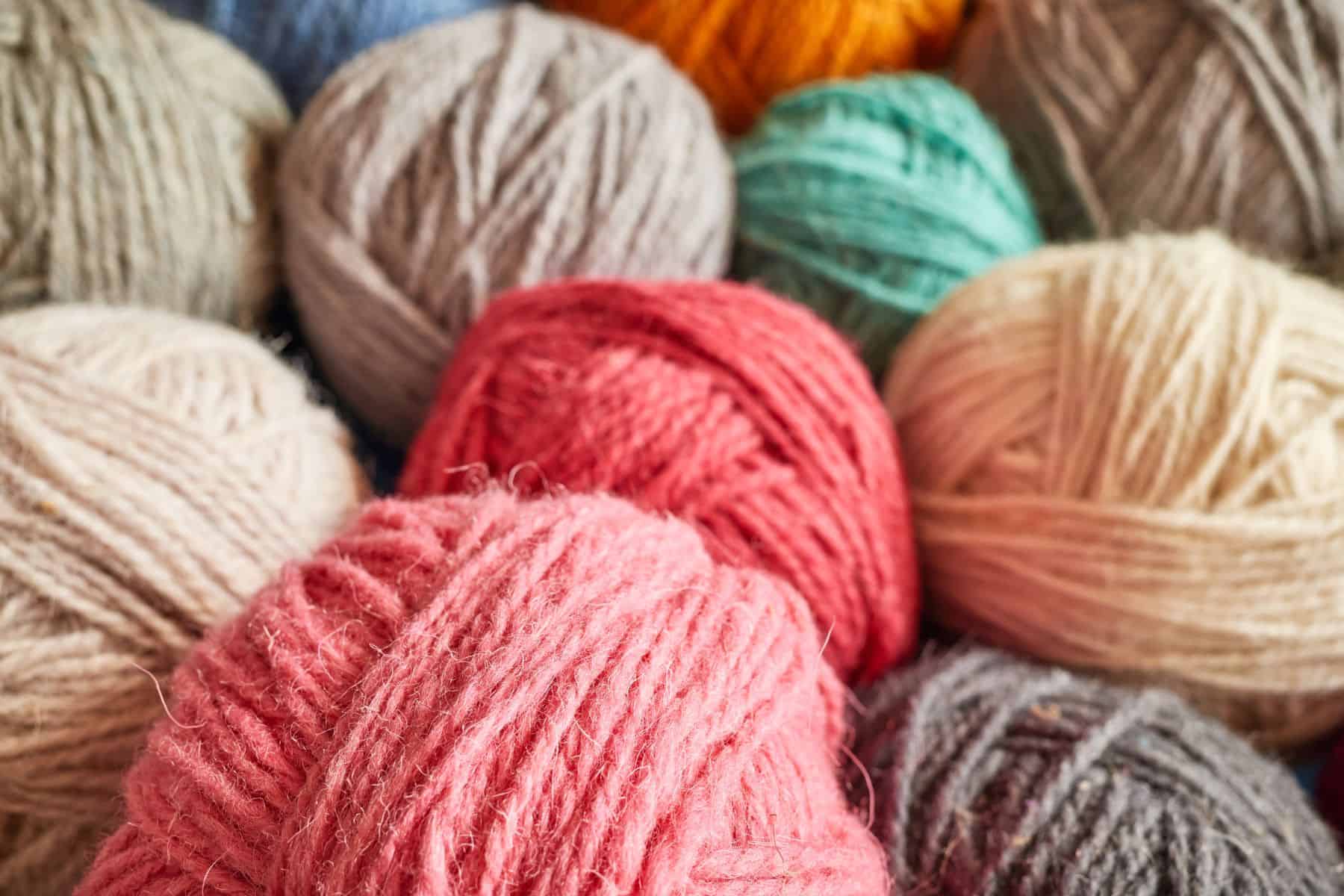 A variety of balls of yard in playful colors for knitting group.